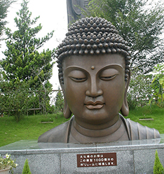 large outdoor temple building buddha bust statue